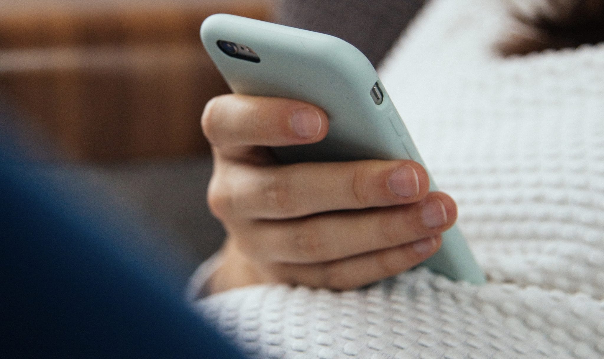 Girl holding phone to get help now with lifehouse