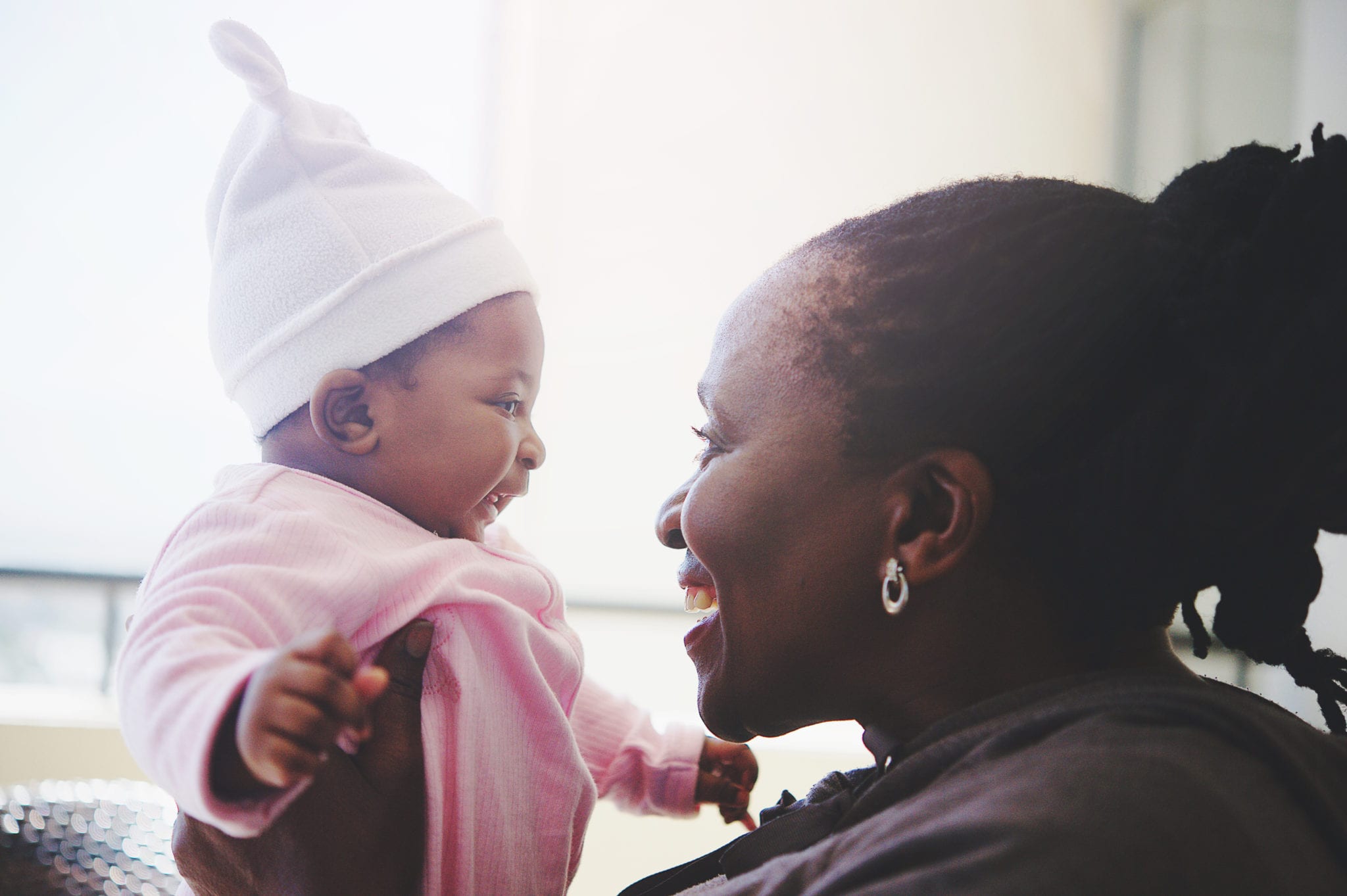 grandmother and baby granddaughter intimate time side view