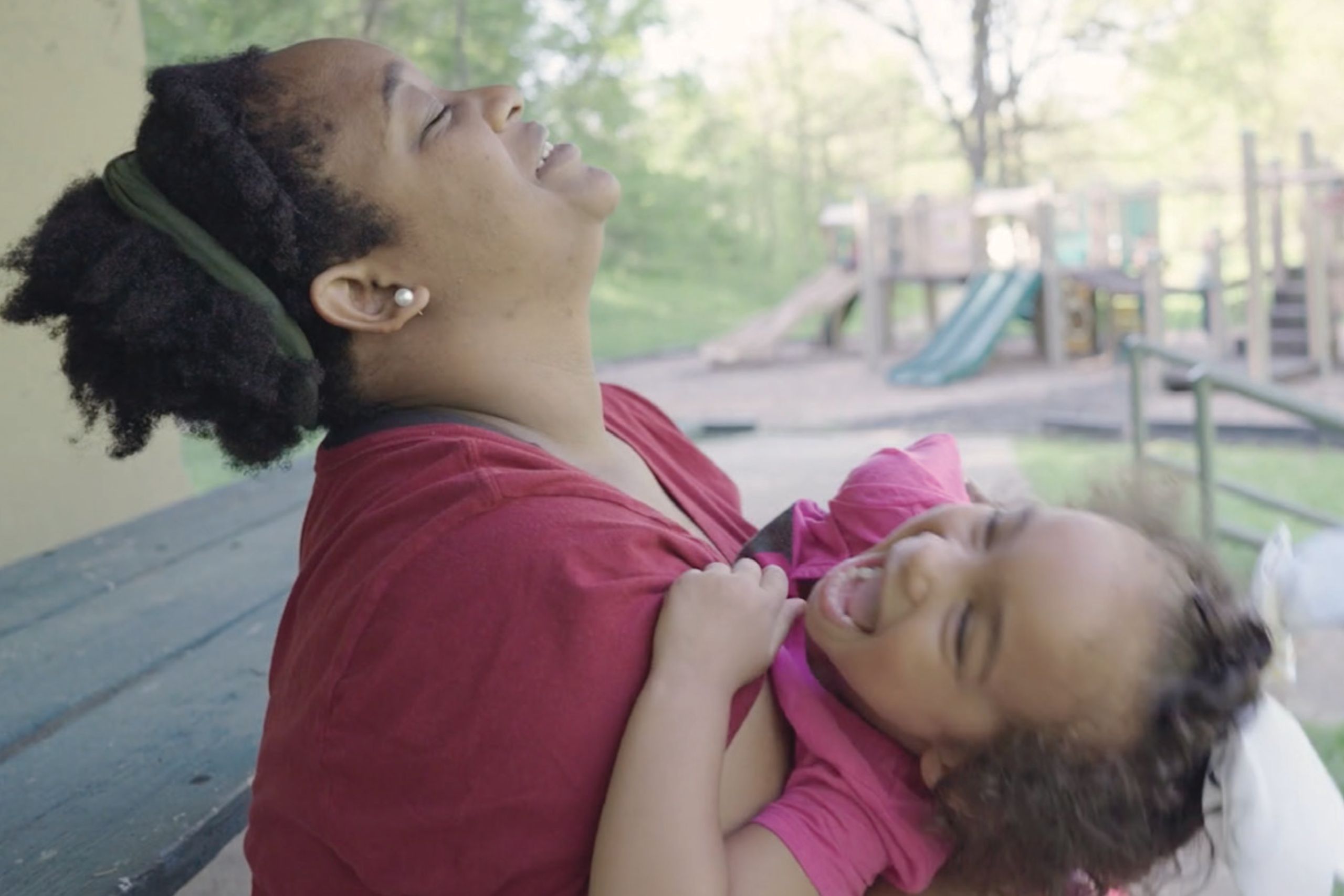 Mom playing with smiling daughter