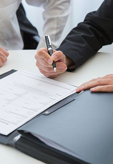 Screenshot Hands getting ready to sign a financial document
